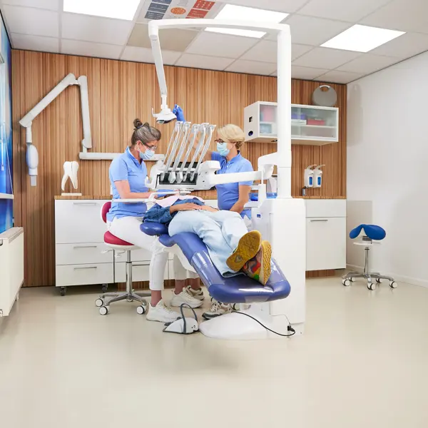 Tandartspraktijk met tandarts aan het werk